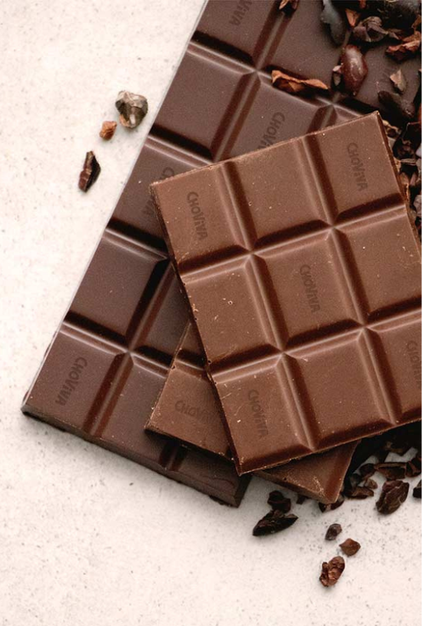 A hand holds a pack of REWE Peanut Butter Cups.